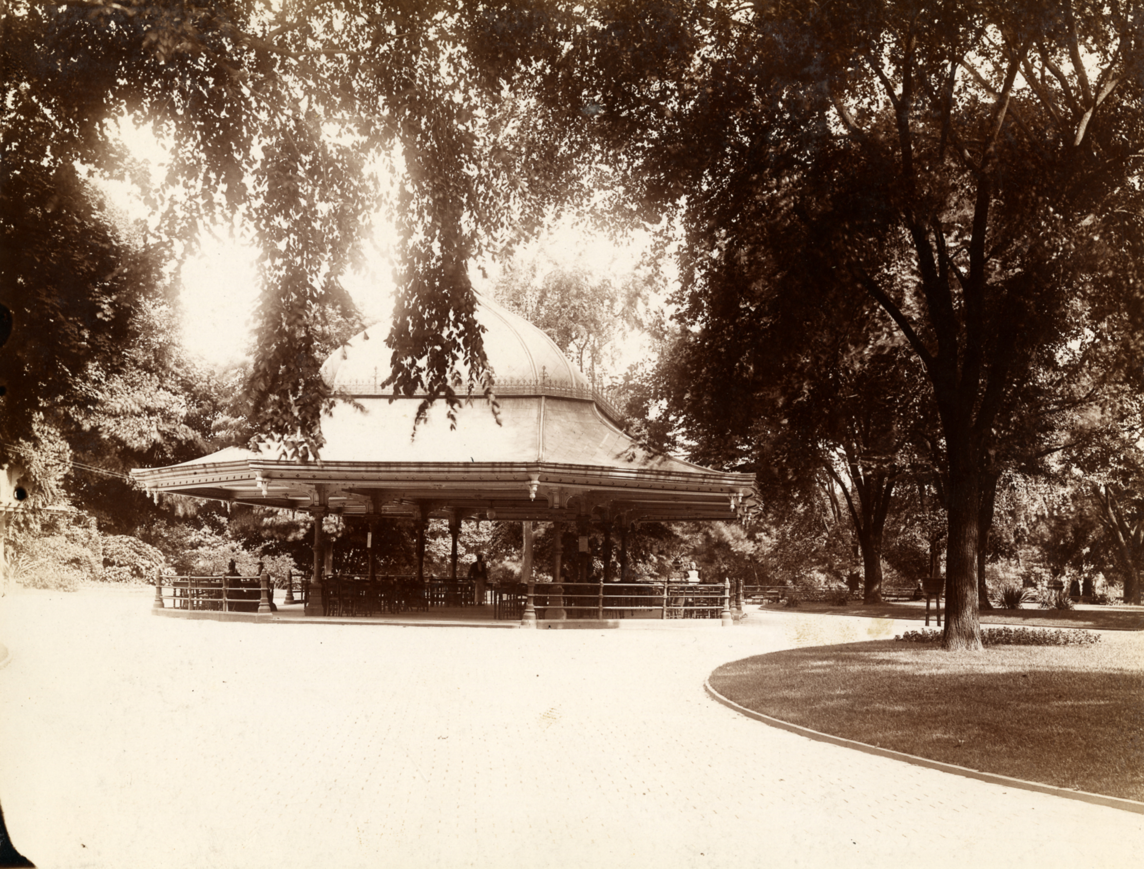 Sepia photograph of the Concert Grove Pavilion, an ornate rooftop on cast iron legs.
