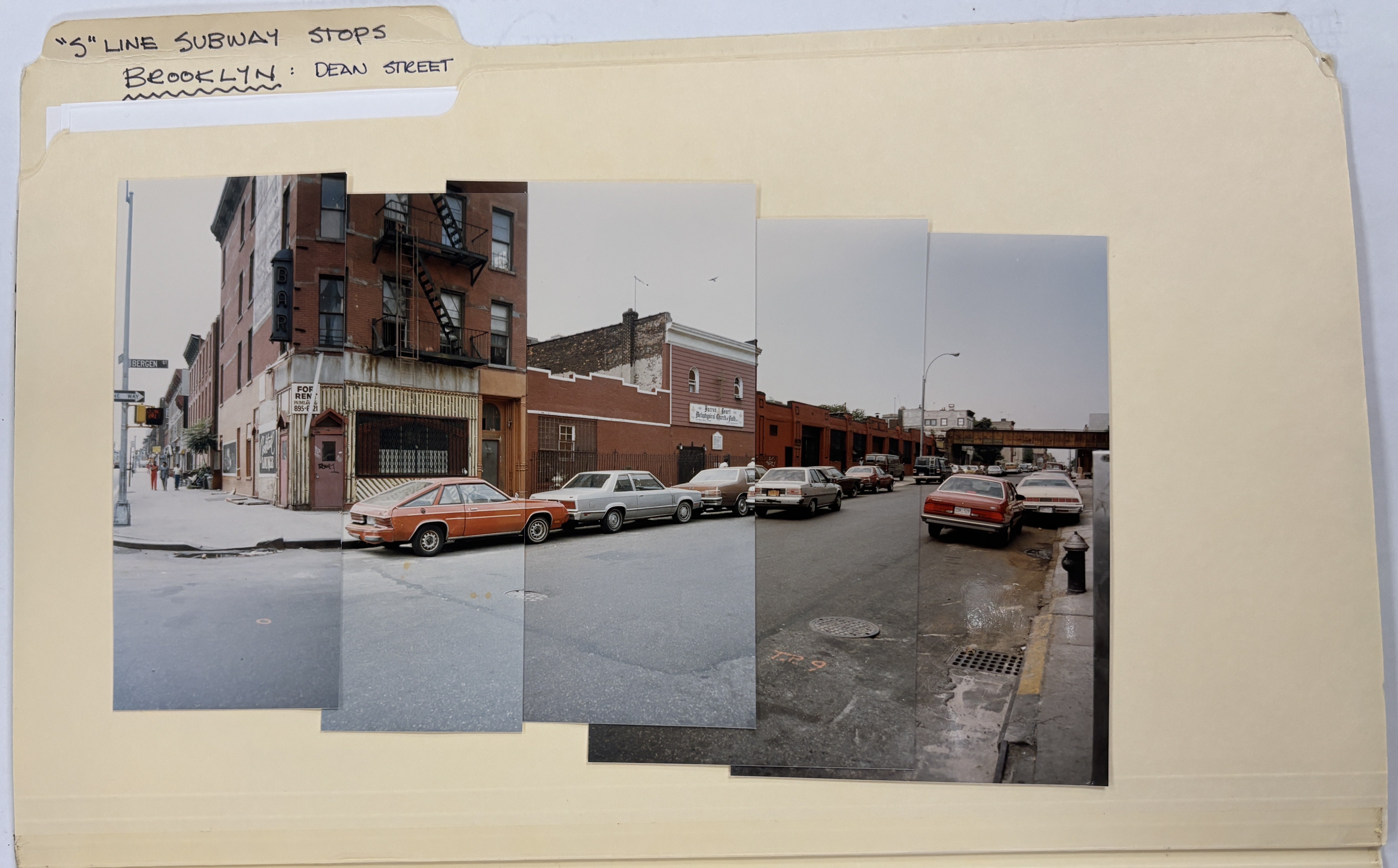 manila folder with photographs of street scene pasted in creating panorama