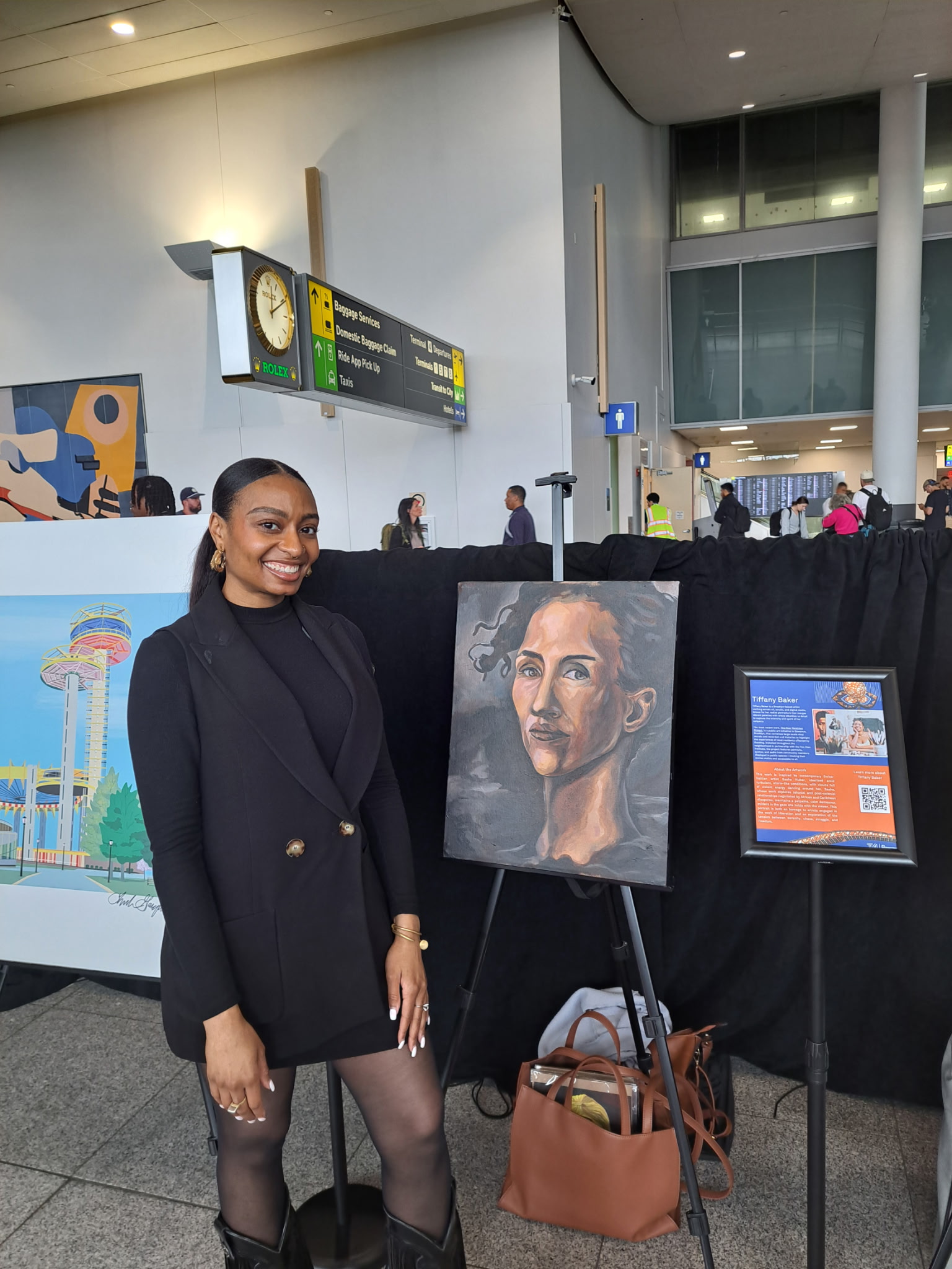 Illustrator Tiffany Baker in front of a portrait