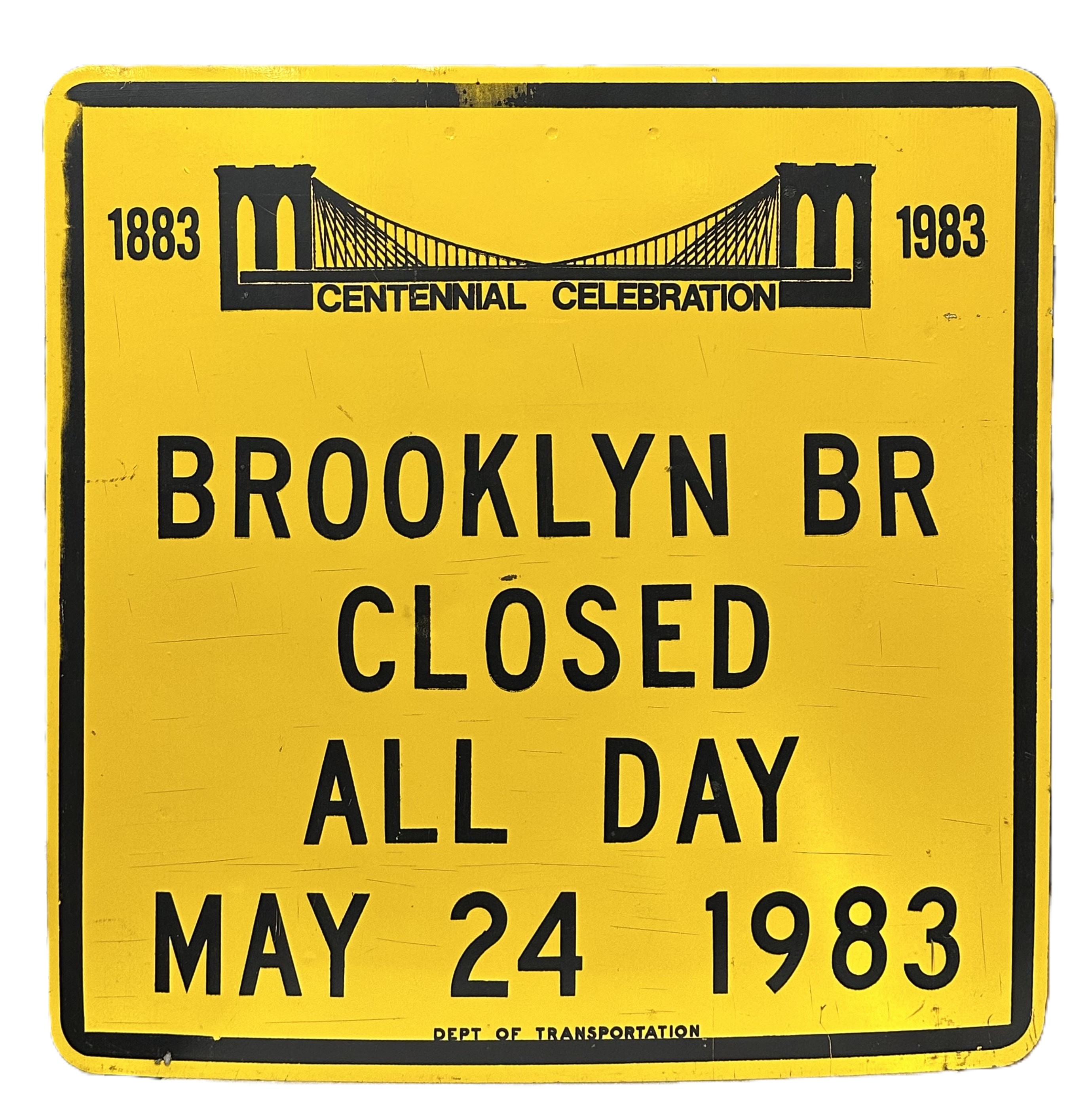 Yellow traffic sign with black text and logo of the Brooklyn Bridge announcing closures for the bridge centennial celebration.