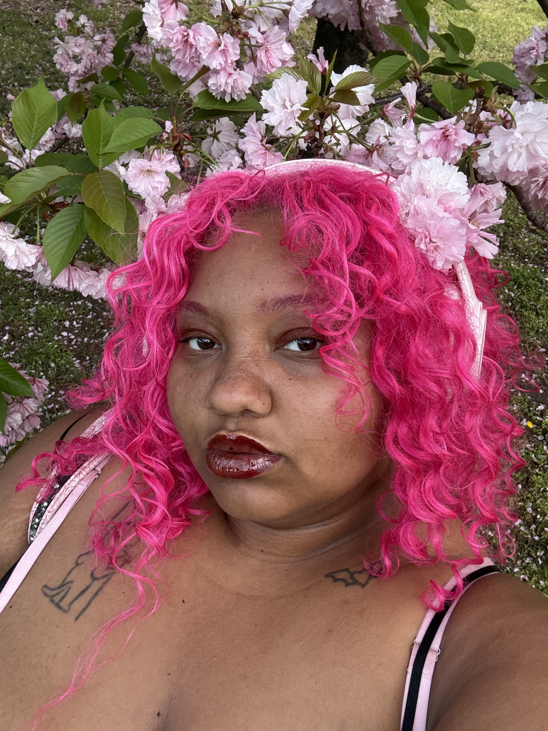 pink haired figure surrounded by flowers