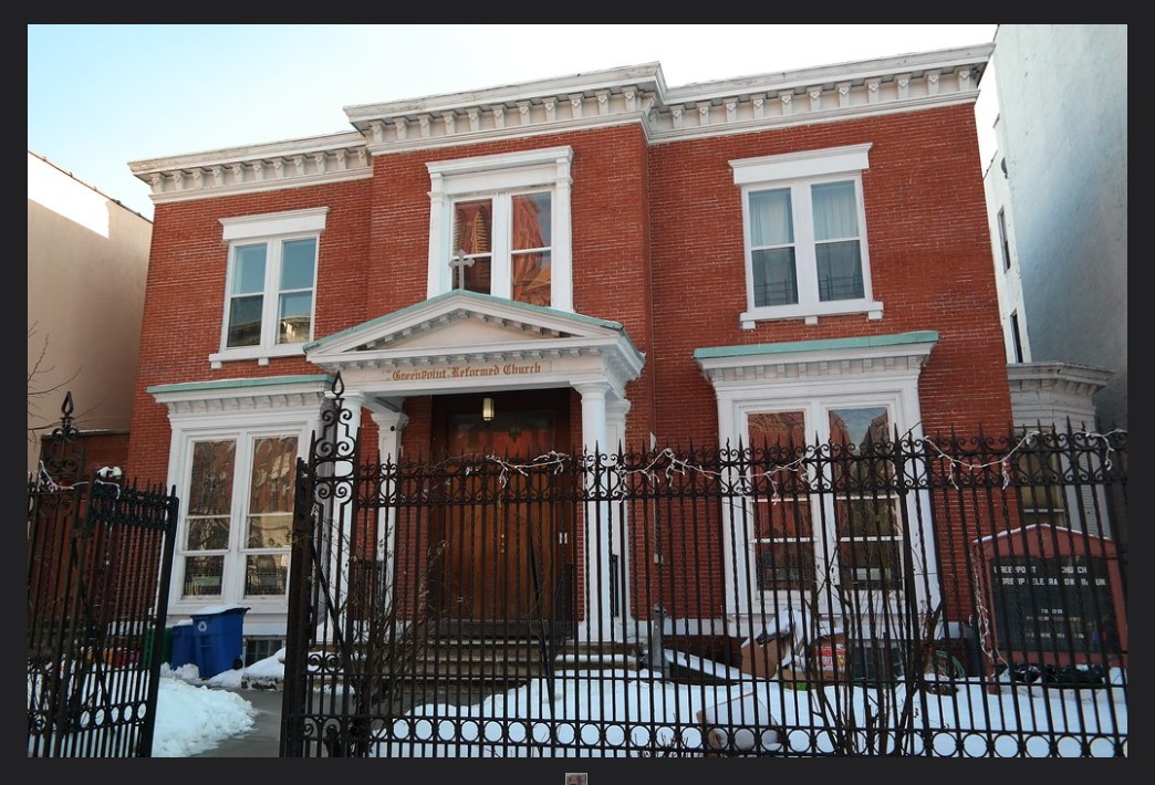 Red brick house with greek style porch and white trim
