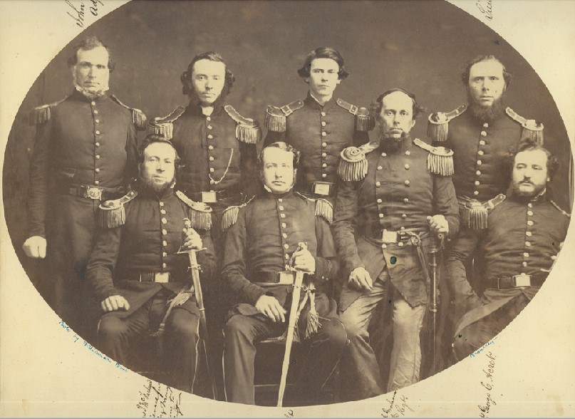 Sepia photograph of 8 men dressed in Civil War uniforms.