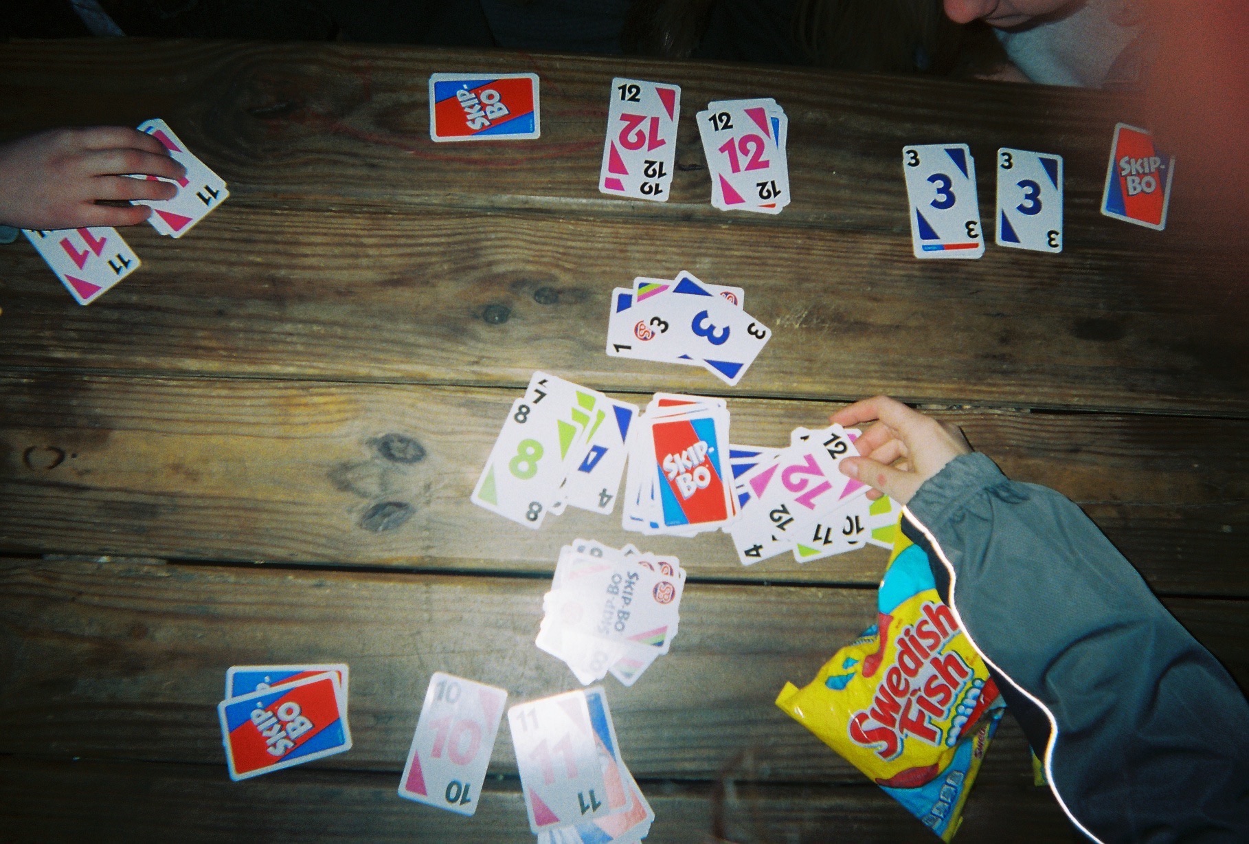 Card game with a bag of swedish fish and various hands