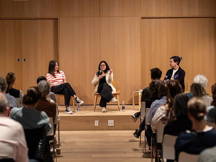 Kate Chin Park and Wyna Liu speak on a stage to a room full of people as a moderator looks on.