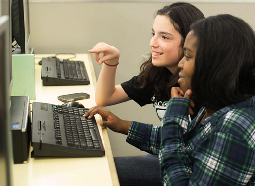photo of two teens using a computer