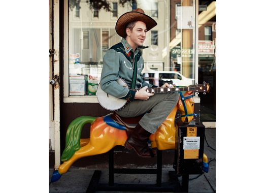 Hopalong Andrew on a drug store horse ride with a banjo.