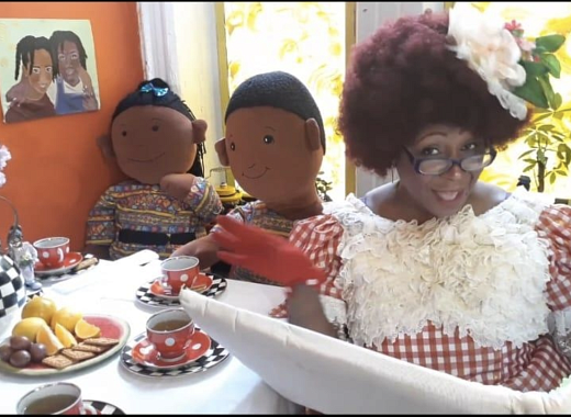 Aunt Tea Goose reading a story with some dolls