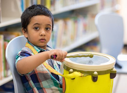 photo of a kid banging a drum