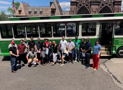Teachers in front of a trolly. 