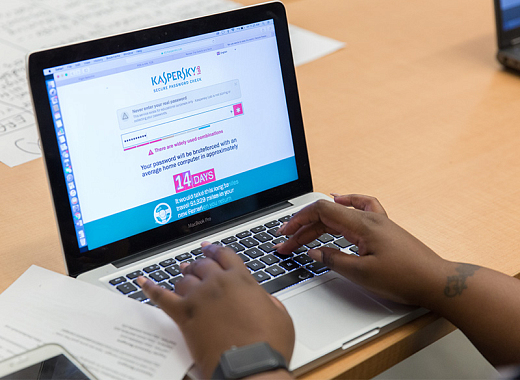 photo of hands typing on a laptop on a table